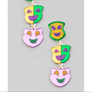 Colorful Mardi Gras-themed earrings on a gray background