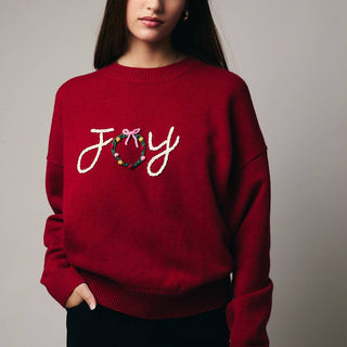 Red sweater with 'Joy' and a wreath design 