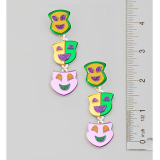 Colorful owl-shaped earrings with a ruler for scale on a white background