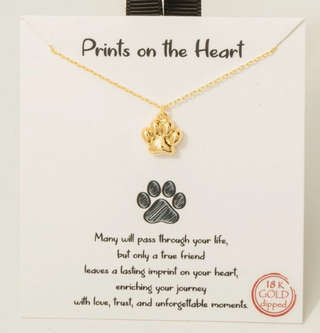 A gold paw print necklace 