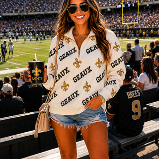 Woman at a sports event wearing a 'Geaux' shirt with Saints branding.